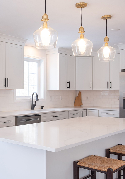 Modern kitchen remodel with custom cabinetry, stone countertops, and a large island